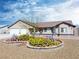 Charming single-story home boasts desert landscaping and a two-car garage under a bright blue sky at 340 Domingo St, Pahrump, NV 89048