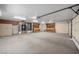 Open two-car garage with cabinets, bright lighting, and ample workspace at 340 Domingo St, Pahrump, NV 89048