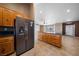 Open kitchen featuring an island with wooden cabinets and black countertops at 340 Domingo St, Pahrump, NV 89048