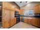 Traditional kitchen with stainless steel appliances, breakfast bar, and light wood cabinets at 340 Domingo St, Pahrump, NV 89048