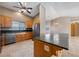 Open concept kitchen with stainless steel appliances and a large island with breakfast bar seating at 340 Domingo St, Pahrump, NV 89048