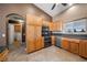 Well-equipped kitchen with stainless appliances, tile countertops, wood cabinets, and lots of storage at 340 Domingo St, Pahrump, NV 89048