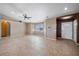 Spacious living room features bright windows, neutral paint, ceiling fan, and beautiful tile flooring at 340 Domingo St, Pahrump, NV 89048