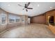 Open living room with tile floors, large windows, and access to kitchen bar area at 340 Domingo St, Pahrump, NV 89048