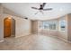 Bright living room features tile floors, neutral walls, ceiling fan and lots of natural light at 340 Domingo St, Pahrump, NV 89048