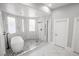 Modern bathroom featuring a sleek soaking tub, glass-enclosed shower, and elegant tile work at 3465 Pama Ln, Las Vegas, NV 89120