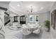 Dining room featuring stylish furnishings, a modern chandelier, and large windows for natural light at 3465 Pama Ln, Las Vegas, NV 89120