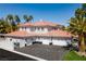 Beautiful exterior view of the house featuring a clay tile roof, multiple garages, and desert landscaping at 3465 Pama Ln, Las Vegas, NV 89120
