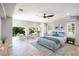 Bright and airy main bedroom featuring large windows, neutral tones, and a ceiling fan for added comfort at 3465 Pama Ln, Las Vegas, NV 89120