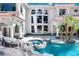 Resort-style pool area with a spa, waterfall feature, and lush landscaping creating a private oasis at 3465 Pama Ln, Las Vegas, NV 89120