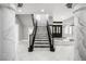 Beautiful staircase with marble steps and wrought iron railings, leading to the upper levels of the home at 3465 Pama Ln, Las Vegas, NV 89120