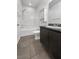 Well-lit bathroom featuring a shower-tub combination and a modern vanity with dark cabinets at 3726 Shaving Shadows Ave, North Las Vegas, NV 89032