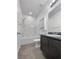 Well-lit bathroom featuring a shower-tub combination and a modern vanity with dark cabinets at 3726 Shaving Shadows Ave, North Las Vegas, NV 89032