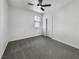 Clean bedroom with a ceiling fan, carpeted floors, and bright neutral walls at 3726 Shaving Shadows Ave, North Las Vegas, NV 89032