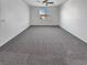 Large bedroom featuring neutral carpet, a ceiling fan, and natural light at 3726 Shaving Shadows Ave, North Las Vegas, NV 89032