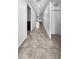 Hallway with tile flooring, neutral walls, and access to different areas of the home at 3726 Shaving Shadows Ave, North Las Vegas, NV 89032