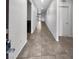 Well-lit hallway featuring tile floors, neutral walls, and doors leading to various rooms at 3726 Shaving Shadows Ave, North Las Vegas, NV 89032