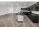 Spacious kitchen with dark cabinetry, granite countertops, and an island with a sink at 3726 Shaving Shadows Ave, North Las Vegas, NV 89032