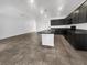 Bright, modern kitchen with dark cabinets, center island and tile floors at 3726 Shaving Shadows Ave, North Las Vegas, NV 89032