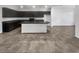 Well-equipped kitchen featuring dark cabinets, a large island and modern appliances at 3726 Shaving Shadows Ave, North Las Vegas, NV 89032