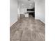 Open-concept kitchen and living area featuring tile flooring, a center island, and modern cabinetry at 3726 Shaving Shadows Ave, North Las Vegas, NV 89032