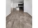 Modern kitchen with dark cabinets, a center island, and neutral tile flooring at 3726 Shaving Shadows Ave, North Las Vegas, NV 89032