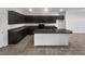 Modern kitchen features dark cabinets, granite countertops and island at 3726 Shaving Shadows Ave, North Las Vegas, NV 89032