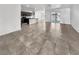Open-concept living space with tile flooring, connecting the kitchen and dining areas at 3726 Shaving Shadows Ave, North Las Vegas, NV 89032