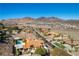 Scenic aerial view showing a desert home with palm trees and easy access to community amenities at 380 Claremont St, Boulder City, NV 89005