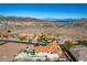 Expansive aerial view featuring a desert home with a private pool and mountain backdrop at 380 Claremont St, Boulder City, NV 89005