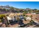 An aerial shot of a sprawling home with a tile roof, beautiful landscaping, and a long driveway at 380 Claremont St, Boulder City, NV 89005