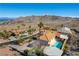 High angle view showcasing a desert home with a private pool, tile roof, and lush landscaping at 380 Claremont St, Boulder City, NV 89005