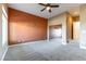This bedroom offers carpeted floors, a decorative ceiling fan and large windows that provide ample natural light at 380 Claremont St, Boulder City, NV 89005