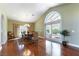 Bright dining room with wood floors, large arched windows, and sliding glass door at 380 Claremont St, Boulder City, NV 89005
