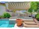 Relaxing hot tub area shaded by a stylish pergola, perfect for outdoor lounging at 380 Claremont St, Boulder City, NV 89005