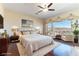 Serene main bedroom with a luxurious bed, seating area, and a picturesque outdoor view at 380 Claremont St, Boulder City, NV 89005