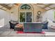 Inviting covered patio with stylish wicker furniture, ceiling fans, and a view through sliding glass doors at 380 Claremont St, Boulder City, NV 89005