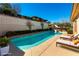 Inviting backyard featuring a sparkling blue pool, lounge chairs, and manicured landscaping at 380 Claremont St, Boulder City, NV 89005