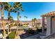 Community street view with palm trees, manicured lawns, and views of the lake and mountains at 380 Claremont St, Boulder City, NV 89005