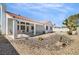 The backyard offers a covered patio and low maintenance desert landscaping at 4032 Bola Dr, North Las Vegas, NV 89032