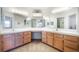 Bright bathroom featuring dual sinks with a large mirror and neutral colors at 4032 Bola Dr, North Las Vegas, NV 89032