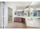 The bright bathroom offers dual sinks, a large mirror, and a glass-enclosed shower at 4032 Bola Dr, North Las Vegas, NV 89032