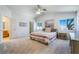 This bedroom offers plush carpet, a ceiling fan, and natural light from dual windows at 4032 Bola Dr, North Las Vegas, NV 89032