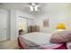 Cozy bedroom with neutral carpet, mirrored closet, and a ceiling fan for comfort at 4032 Bola Dr, North Las Vegas, NV 89032