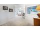 Bright bedroom with neutral carpet, plenty of natural light, and comfortable seating at 4032 Bola Dr, North Las Vegas, NV 89032