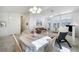 Inviting dining area with chandelier lighting and views into the living room enhances the dining experience at 4032 Bola Dr, North Las Vegas, NV 89032