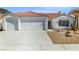 Charming single-story home with a two-car garage, desert landscaping, and a red tile roof at 4032 Bola Dr, North Las Vegas, NV 89032