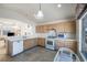 Bright kitchen boasts natural wood cabinets, white appliances and plenty of countertop space at 4032 Bola Dr, North Las Vegas, NV 89032