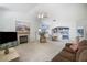 Open-concept living area with fireplace and views into the kitchen provides flexible space for living at 4032 Bola Dr, North Las Vegas, NV 89032