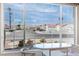 Inviting sitting area with large grid windows showcasing neighborhood views and desert landscaping at 4032 Bola Dr, North Las Vegas, NV 89032